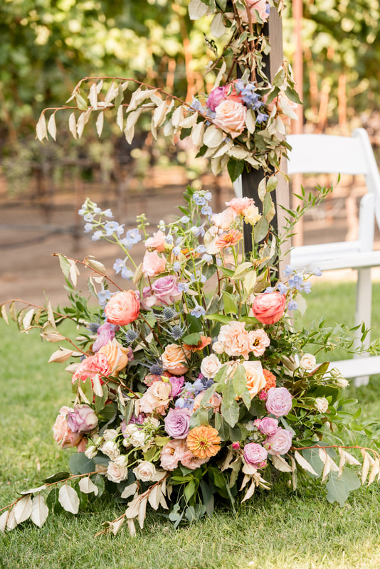 Outdoor wedding ceremony with a flower-covered Chuppah