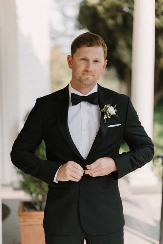 Groom in a classic black tuxedo from The Black Tux