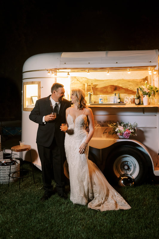 bride and groom with mobile bar at wedding