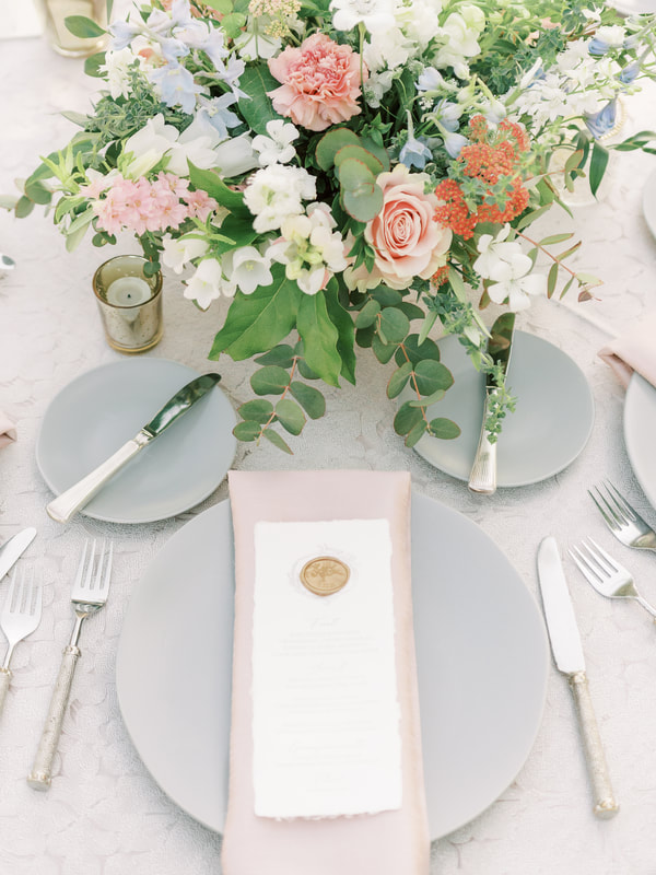 Wedding reception with lace linens and gray plates, with blush napkins
