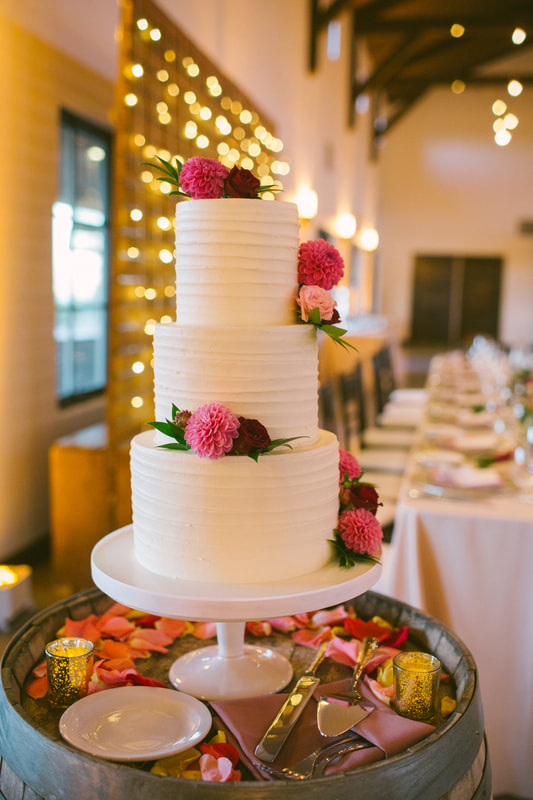 white wedding cake with colorful flowers