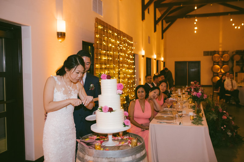 bride and groom cutting cake at Viansa Winery